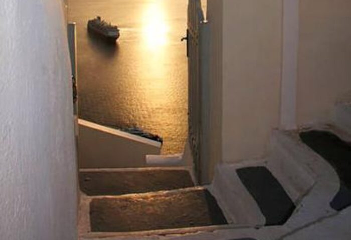 Stairs at Gay-Friendly Keti Hotel lead to sea view. Cruise ship on the water at sunset. A great place for gay travel in Greece.