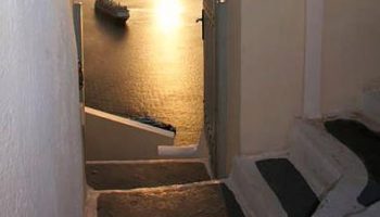 Stairs at Gay-Friendly Keti Hotel lead to sea view. Cruise ship on the water at sunset. A great place for gay travel in Greece.
