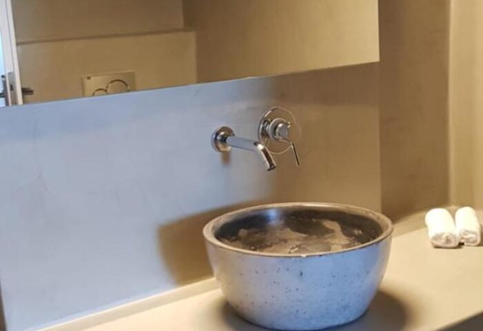 Keti Hotel's bathroom. Modern design, round sink, mirror, towels. Gay-friendly hotel, stylish interior. Ideal for gay travelers.