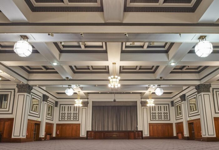 Grand ballroom at the gay-friendly Kimpton Clocktower Hotel. Ornate ceiling, chandeliers, and a stage. Perfect for events.
