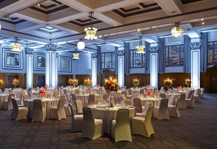 Kimpton Clocktower Hotel ballroom. Round tables with white linens, floral centerpieces, and candles. Gay-friendly hotel event space.
