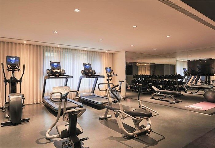Kimpton Da An Hotel's gym. Treadmills, elliptical, and weights offer a complete workout. A gay-friendly hotel with fitness options.