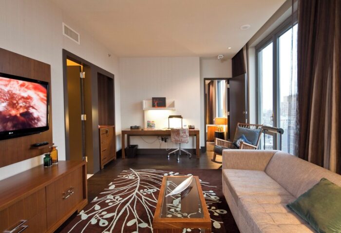 Kimpton Hotel Eventi suite. Gay-friendly hotel room with desk, sofa, TV, and city views. Modern design for LGBT travelers.