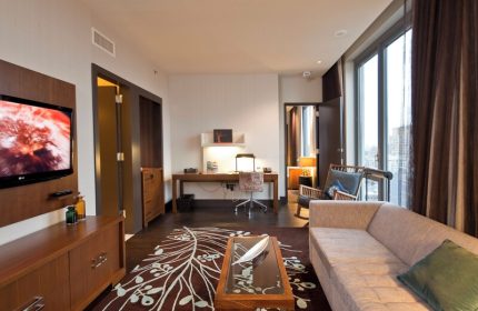 Kimpton Hotel Eventi suite. Gay-friendly hotel room with desk, sofa, TV, and city views. Modern design for LGBT travelers.
