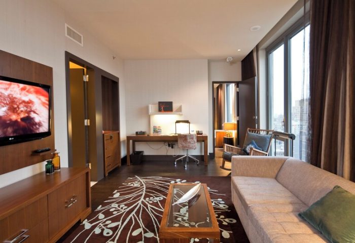 Kimpton Hotel Eventi suite. Gay-friendly hotel room with desk, sofa, TV, and city views. Modern design for LGBT travelers.
