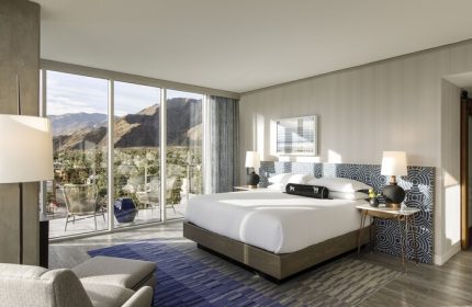 Kimpton Rowan Palm Springs Hotel bedroom with balcony, mountain view. Gay-friendly hotel with modern design, perfect for gay travel.
