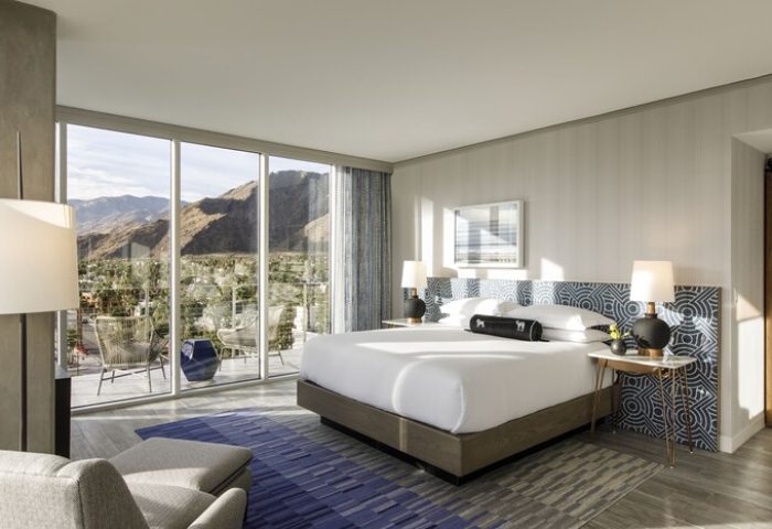 Kimpton Rowan Palm Springs Hotel bedroom with balcony, mountain view. Gay-friendly hotel with modern design, perfect for gay travel.
