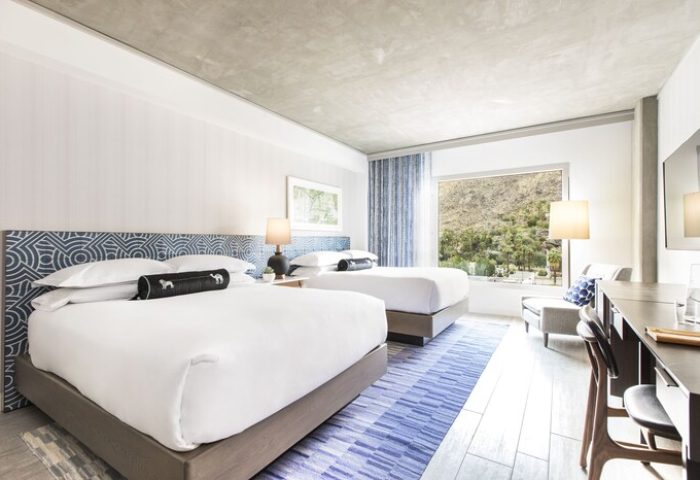 Kimpton Rowan Palm Springs Hotel room with two beds, blue accents, and mountain view. Gay-friendly hotel for gay travelers.