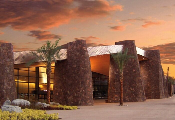 Kimpton Rowan Palm Springs Hotel entrance at sunset. Gay-friendly hotel with modern architecture and palm trees. Palm Springs travel destination.