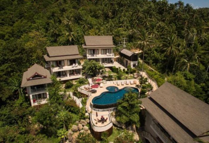 Koh Phangan Pavilions, a gay-friendly hotel. Aerial view of villas and pool surrounded by lush tropical greenery. Ideal for gay travel.