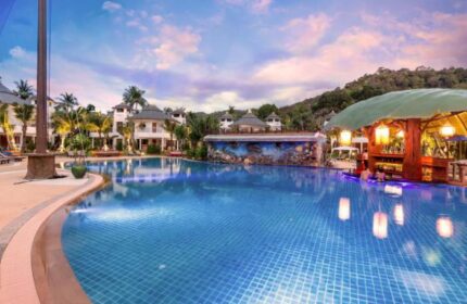 Krabi Resort Pool Villa, a gay-friendly hotel. Features a large pool, swim-up bar, lush greenery, and luxurious villas. Perfect for gay travel.
