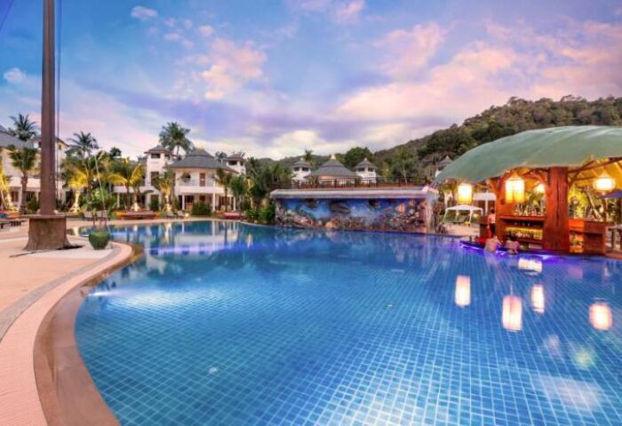 Krabi Resort Pool Villa, a gay-friendly hotel. Features a large pool, swim-up bar, lush greenery, and luxurious villas. Perfect for gay travel.