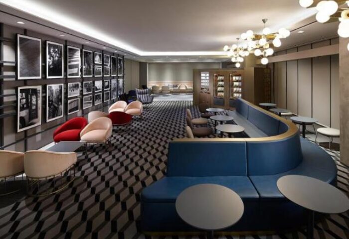 L7 Myeongdong by LOTTE hotel lounge. Stylish seating area with blue couches, chairs, and tables. Gay-friendly hotel interior design.