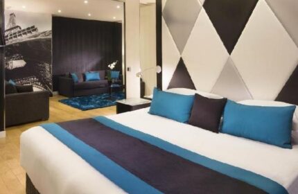 L'Empire Paris Hotel room. Gay-friendly, pet-friendly hotel in Paris. Modern decor, Eiffel Tower art, blue accents. Comfortable stay in Paris.