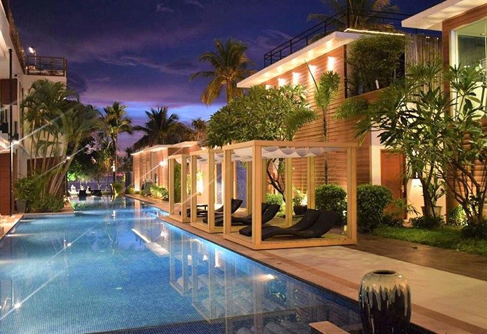 La Flora Resort Patong pool at dusk. Gay-friendly hotel with private cabanas. Luxury travel for gay men in Thailand. #gaytravel #patong