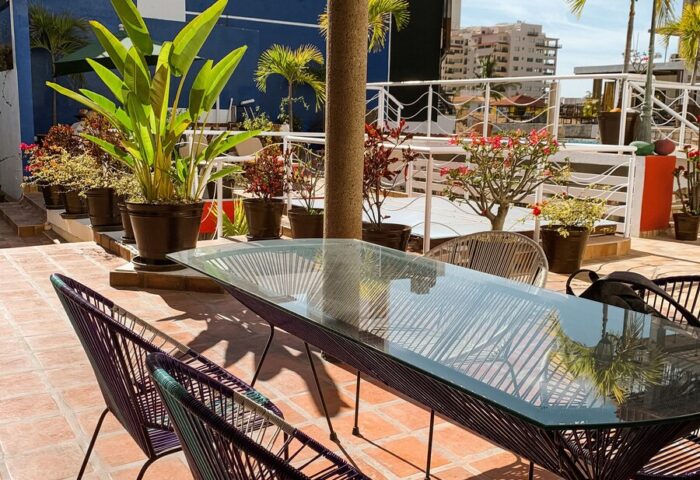 La Iguana Vallarta LGBT adults-only hotel rooftop dining area in Romantic Zone. Gay-friendly hotel with party clubbing street nearby.