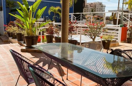 La Iguana Vallarta LGBT adults-only hotel rooftop dining area in Romantic Zone. Gay-friendly hotel with party clubbing street nearby.