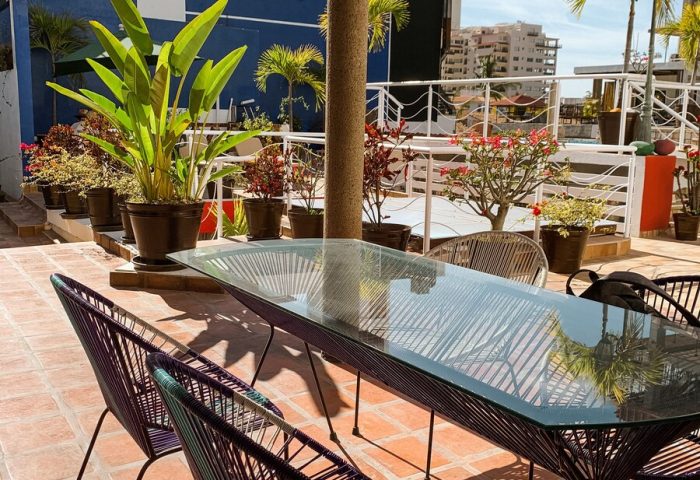 La Iguana Vallarta LGBT adults-only hotel rooftop dining area in Romantic Zone. Gay-friendly hotel with party clubbing street nearby.