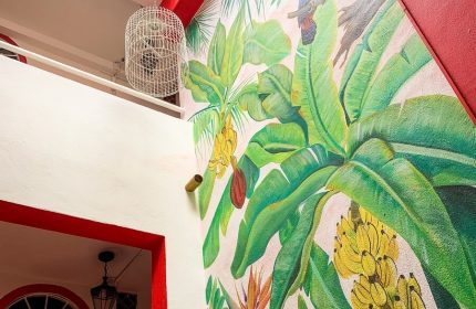 La Iguana Vallarta LGBT adults-only hotel, Romantic Zone. Mural with tropical plants and bird. Gay-friendly hotel in Puerto Vallarta.