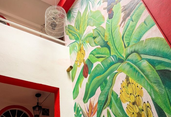 La Iguana Vallarta LGBT adults-only hotel, Romantic Zone. Mural with tropical plants and bird. Gay-friendly hotel in Puerto Vallarta.