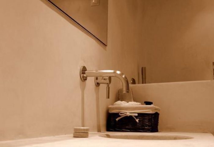 La Maison Kalogera gay-friendly hotel bathroom. Sink, faucet, and shower head. Ideal gay travel accommodations. LGBTQ+ welcoming hotel.