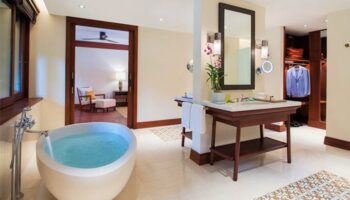 Bathroom at La Residence d'Angkor, a Belmond Hotel in Siem Reap. Gay-friendly hotel with tub, sink, mirror, & closet. Luxury travel.