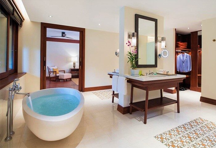 Bathroom at La Residence d'Angkor, a Belmond Hotel in Siem Reap. Gay-friendly hotel with tub, sink, mirror, & closet. Luxury travel.