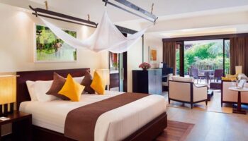 La Residence d'Angkor, a Belmond Hotel, Siem Reap: Luxurious bedroom with a king-size bed, lounge area, and balcony. Gay-friendly hotel.