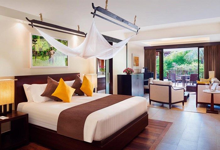 La Residence d'Angkor, a Belmond Hotel, Siem Reap: Luxurious bedroom with a king-size bed, lounge area, and balcony. Gay-friendly hotel.