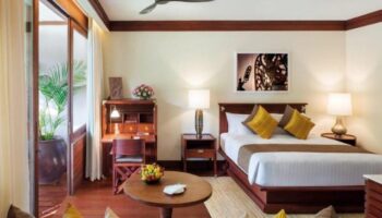 La Residence d'Angkor, a Belmond Hotel, Siem Reap room. Gay-friendly hotel with desk, bed, & balcony. Perfect for gay travel.