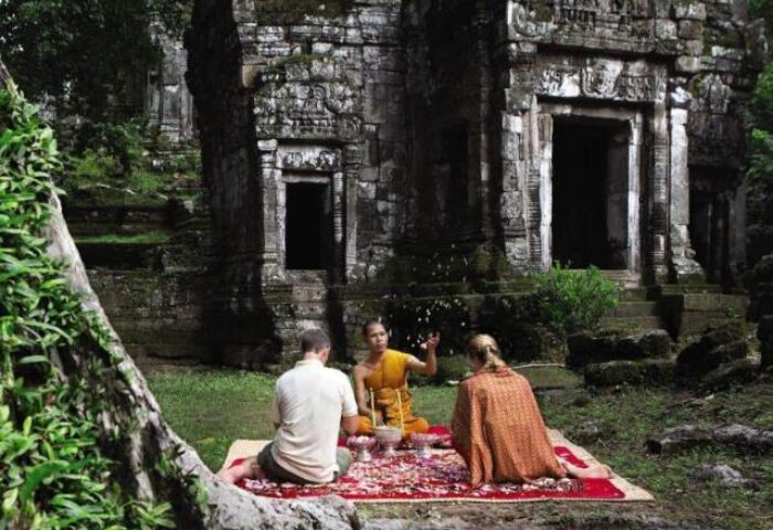 La Residence d'Angkor, a Belmond Hotel, Siem Reap: Monk blessing at ancient temple. Gay-friendly hotel experience in Cambodia.