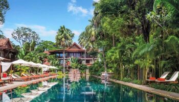 La Residence d'Angkor, A Belmond Hotel, Siem Reap pool view. Gay-friendly hotel with lush greenery, ideal for gay men travel advice.