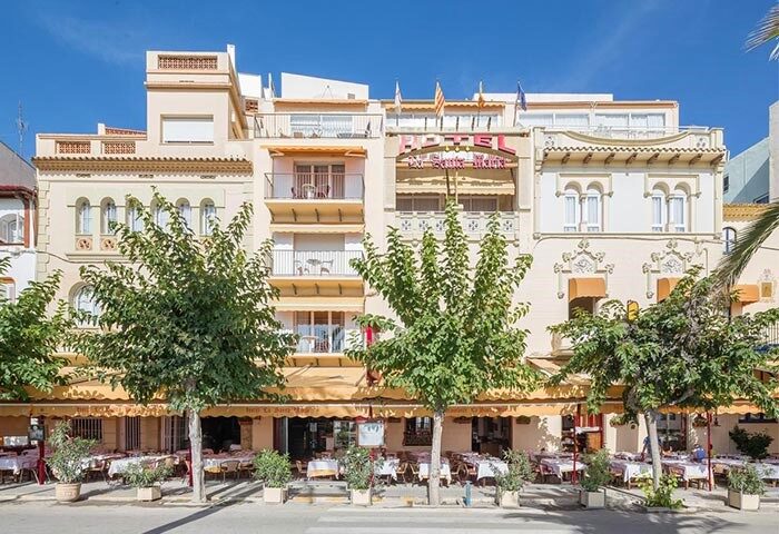 La Santa Maria, a gay-friendly hotel. Exterior view of the hotel with outdoor dining, catering to gay men's travel needs.