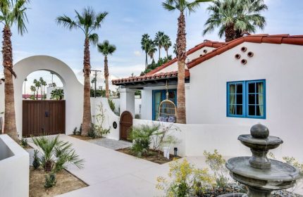 La Serena Villas, a Kirkwood Collection Hotel. Gay-friendly hotel exterior with white walls, palm trees, fountain, and blue window frames.