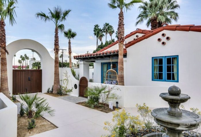 La Serena Villas, a Kirkwood Collection Hotel. Gay-friendly hotel exterior with white walls, palm trees, fountain, and blue window frames.