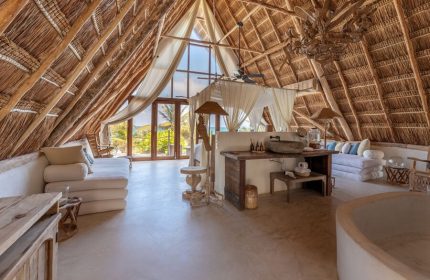 La Valise Tulum gay-friendly hotel room. Thatched roof, king bed, and beach view. Ideal for gay travel in Tulum, Mexico. Luxury suite.