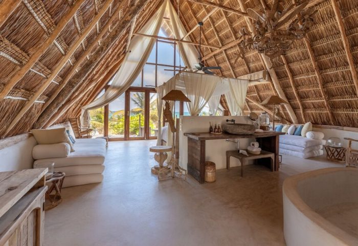 La Valise Tulum gay-friendly hotel room. Thatched roof, king bed, and beach view. Ideal for gay travel in Tulum, Mexico. Luxury suite.