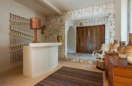 La Valise Tulum's interior. A gay-friendly hotel with stone walls, wooden accents, and a unique design. Perfect for gay men's travel in Tulum.