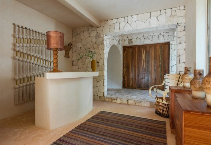 La Valise Tulum's interior. A gay-friendly hotel with stone walls, wooden accents, and a unique design. Perfect for gay men's travel in Tulum.