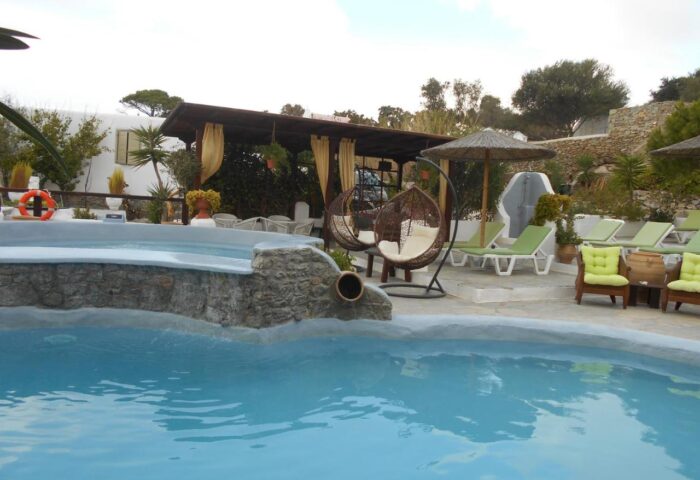 Pool area at La Veranda of Mykonos Traditional Guesthouse, a gay-friendly hotel. Relaxing spot for gay travelers in Mykonos, Greece.