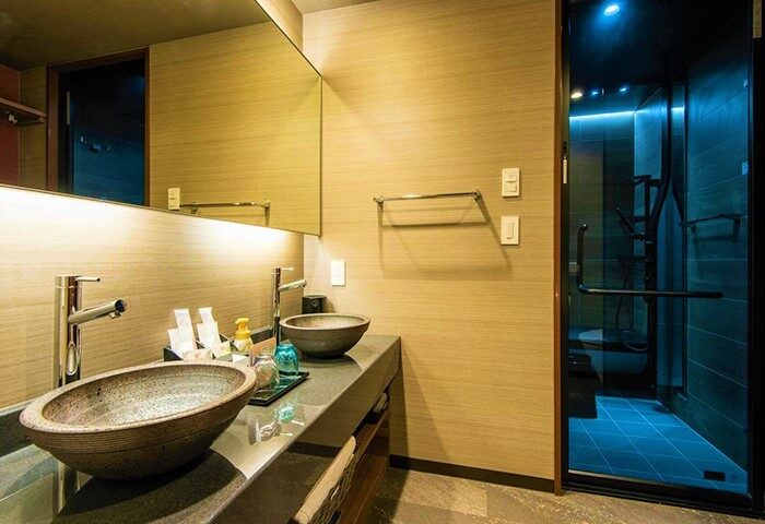 Bathroom at La'gent Hotel Shinjuku Kabukicho, a gay-friendly hotel. Features dual vessel sinks, a large mirror, & a modern shower.