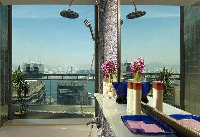 Lan Kwai Fong Hotel gay-friendly room. Shower with a city view. Kau U Fong hotel bathroom with flowers and toiletries. Hong Kong travel.