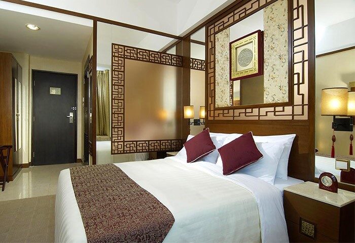 Lan Kwai Fong Hotel @ Kau U Fong room. Gay-friendly hotel bedroom with king bed, Asian decor, and frosted glass divider. Ideal for gay travel.