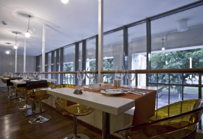 Lanchid 19 Design Hotel's restaurant. Gay-friendly, pet-friendly hotel with modern design. Tables set near large windows.