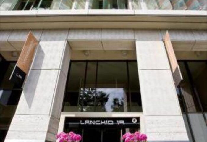 Lanchid 19 Design Hotel entrance. Gay-friendly, pet-friendly hotel architecture. Pink flowers decorate the entrance of this modern hotel.