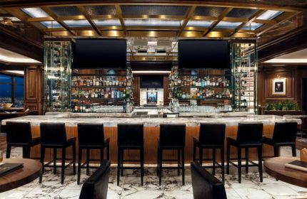 Bar at gay-friendly Las Vegas Hilton at Resorts World. Upscale design, marble floor, liquor selection, TVs. Perfect for gay travelers.