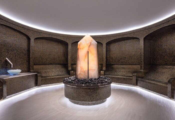 Las Vegas Hilton at Resorts World spa. Gay-friendly hotel features a salt crystal centerpiece, mosaic walls, & relaxing seating. Luxury travel.