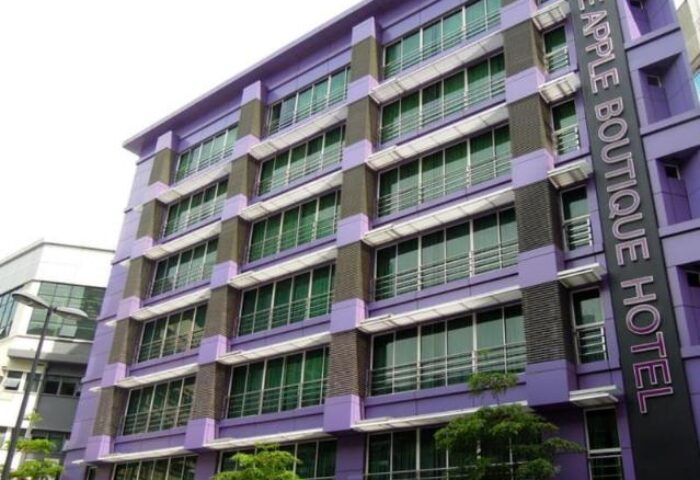 Le Apple Boutique Hotel Bukit Bintang exterior. Gay-friendly hotel in Kuala Lumpur, Malaysia. Modern purple building with many windows.