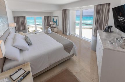 Le Blanc Resort Cancun adults-only all-inclusive gay-friendly hotel. Ocean view room with king bed and balcony overlooking turquoise water.