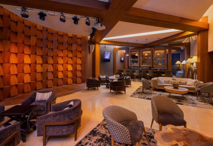 Le Blanc Resort Cancun Adults Only All Inclusive gay-friendly hotel bar lounge area with stage, seating, and warm lighting.